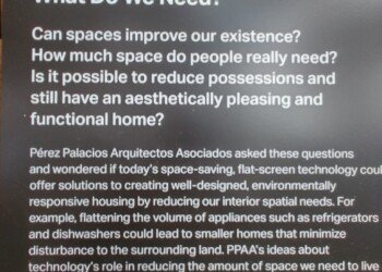 Museum exhibit placard discussing minimal living space design, asking how much space people really need.