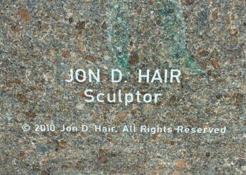 Sculptor plaque reading Jon D. Hair, dated 2010, at the base of the World's Largest Bronze Falcon statue