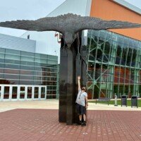 Zach looking up at the World's Largest Bronze Falcon's wingspan at Bowling Green State University